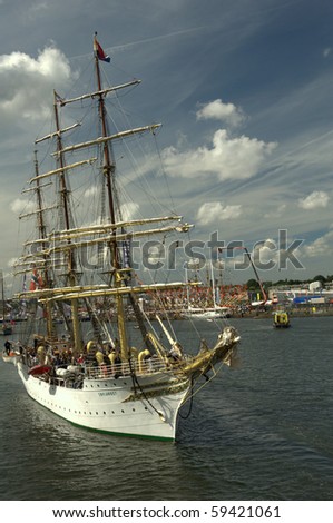 AMSTERDAM, THE NETHERLANDS - AUGUST  19: Tall ships sail in formation through the North Sea Canal on August 19, 2010 in Amsterdam, Holland. The sail parade attracts around 2 million visitors