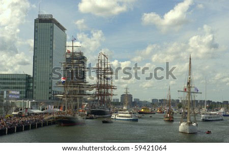 AMSTERDAM, THE NETHERLANDS - AUGUST  1: Tall ships sail in formation through the North Sea Canal on August 19, 2010 in Amsterdam, Holland. The sail parade attracts around 2 million visitors9