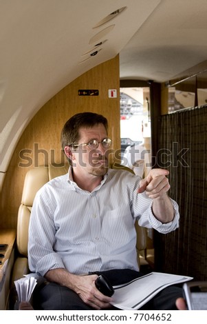Business Executive on Corporate Jet Pointing
