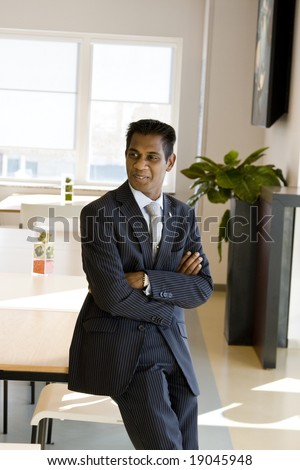 Indian Business Man with Arms Folded Indoors