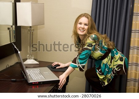 Young Happy Female Clicking Mouse on Laptop Computer