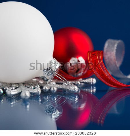 White, silver and red christmas ornaments on dark blue background with space for text. Merry christmas card. Winter holidays. Xmas theme.