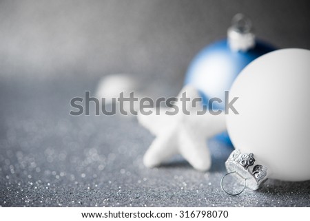 Blue and white xmas ornaments on glitter holiday background. Merry christmas card. Winter holidays. Xmas theme.
