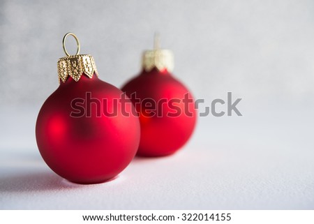 Red xmas ornaments on glitter holiday background. Winter holidays. Xmas theme. Copy space.