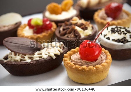 Small cakes with different stuffing - stock photo