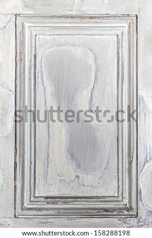 Old distressed wood door panel with peeling paint as framed background