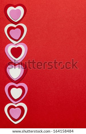 Border of romantic red pink and white hearts for Valentines day on crimson background