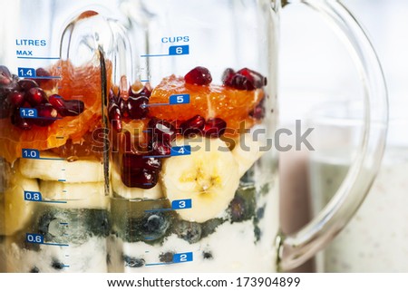 Closeup of healthy smoothie ingredients in blender with fresh fruit