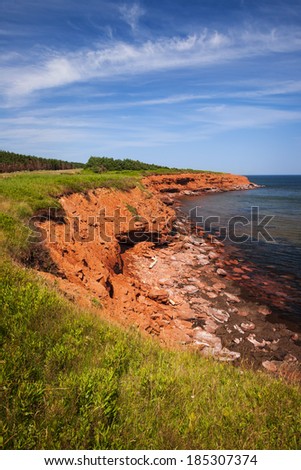 Red cliffs of Prince Edward Island Atlantic coast in Green Gables Shore, PEI, Canada.