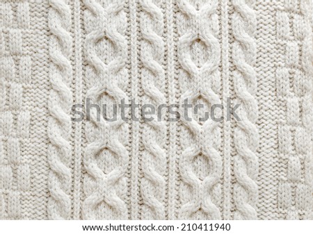 Knit texture of light natural wool knitted fabric with cable pattern as background