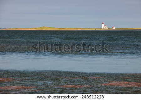 Atlantic ocean landscape with Cascumpec Sandhill lighthouse in Prince Edward Island, Canada