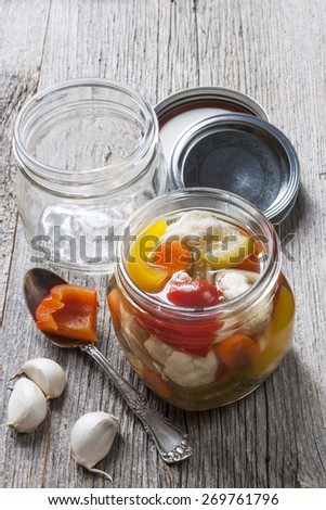 Home preserving mixed vegetables by pickling in glass canning jars