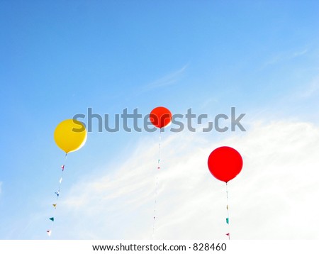 Colorful balloons flying in blue sky on a bright summer day
