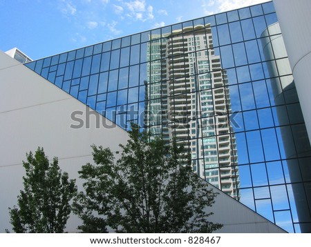 Reflection of a highrise in the mirror wall of an office building