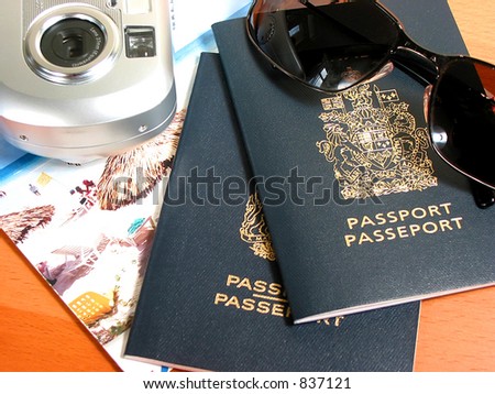 Travel necessities: sunglasses, passports, camera