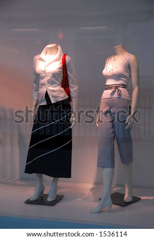 Store window with dressed mannequins in shopping mall