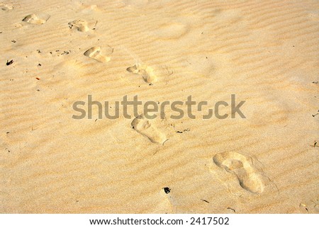 Background of yellow sand surface with footprints