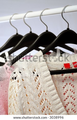 Women\'s clothing on a rack on black hangers