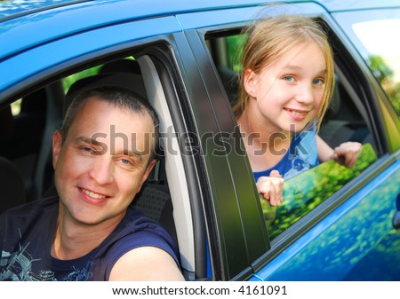 Father and daughter sitting inside the car ready to go on family trip