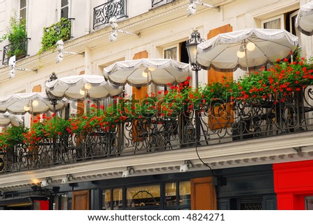 Paris cafe with a balcony patio and umbrellas