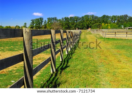 Wooden farm fence and road in rural Ontario, Canada.
