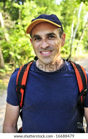 Portrait of happy middle aged man on a forest trail