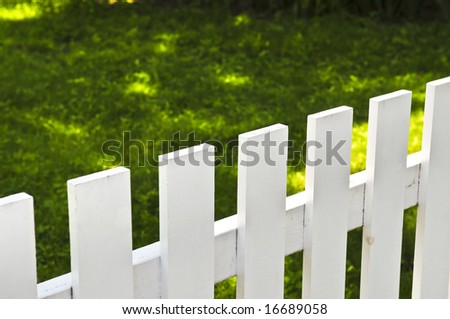 White fence around front yard of residential house
