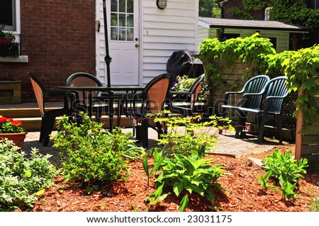 House patio with outdoor furniture and garden