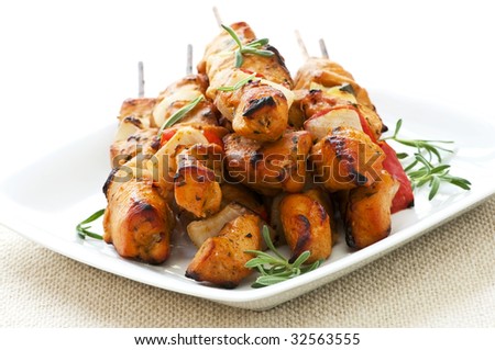 Pile of barbecued chicken kebab appetizers on a plate