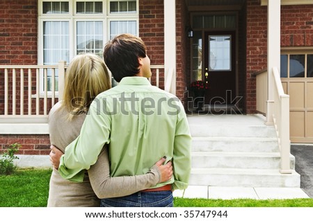 Young happy couple shopping for new home