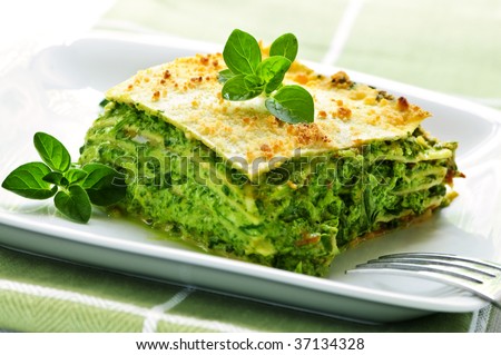 Serving of fresh baked vegeterian spinach lasagna on a plate