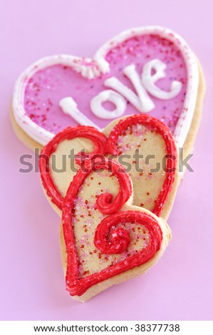 Homemade baked shortbread Valentine cookies with icing on pink background