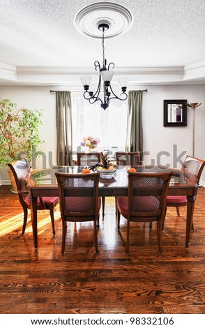 Dining room interior with wooden table and chairs in house
