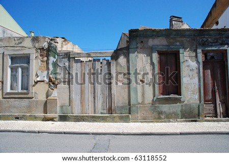 Old house facade with no roof on a blue sky background.