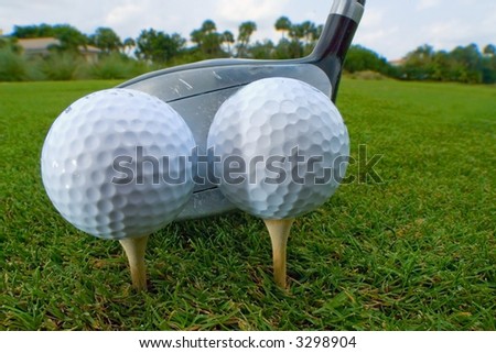 two golf balls teed for one drive for efficiency
