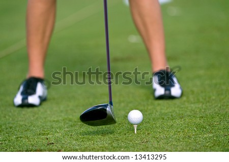 lady golfer practicing at driving range