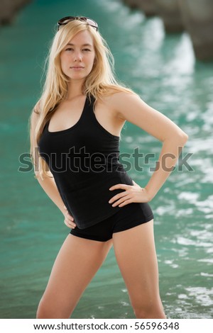 lovely blonde female model under atlantic ocean pier