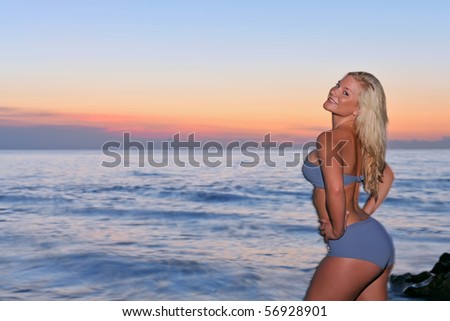 lovely blonde bikini model by atlantic ocean at sunrise, long flash exposure
