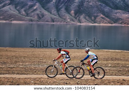 ALMATY, KAZAKHSTAN - APRIL 29: S.Khazov (first) and K.Rachuk in action at Adventure mountain bike cross-country marathon in mountains \