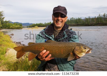 Fishing on river Shishged in the Mongolia - the lenok fish in hand