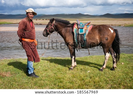 NORTHERN MONGOLIA , MONGOLIA - AUG 06, 2011: Mongolian herder pose for foreign tourists