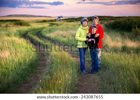 Family traveler posing at sunset near the camp on the prairie