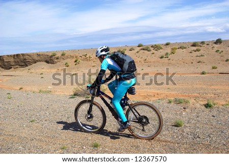 Bike racer in desert mountains