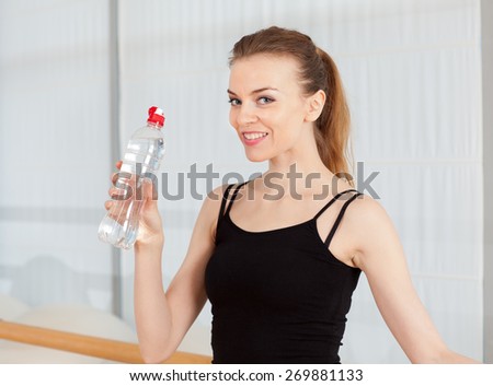 girl drinking water after exercise