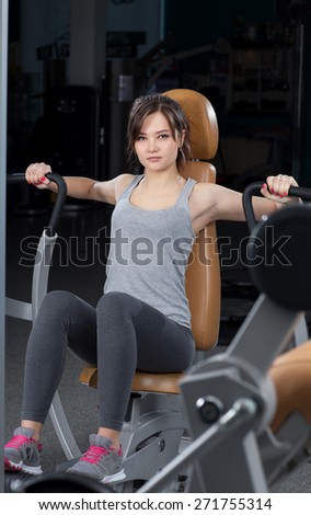 Girl is engaged in the simulator with the coach