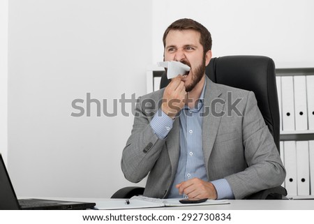 happy man businessman at his desk let a paper airplane