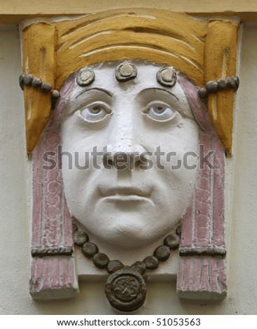 Woman\'s face - detail from the facade of an old building