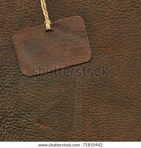 Leather tag on the background of suede
