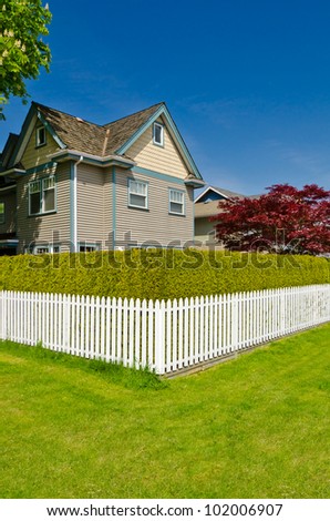 Luxury houses with white fence in Vancouver, Canada.