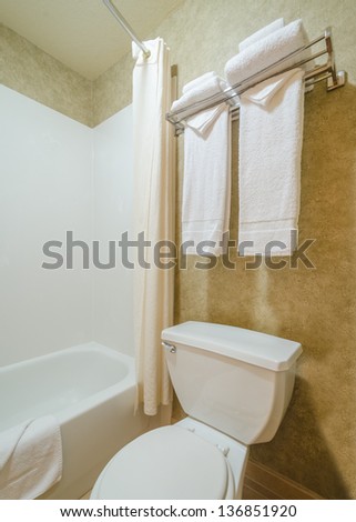 Fragment of a luxury bathroom with a towel on a hanger